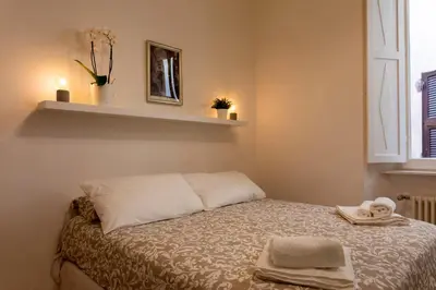 a small bedroom with a bed with towels on it at Casa Cecilia Roma in Rome