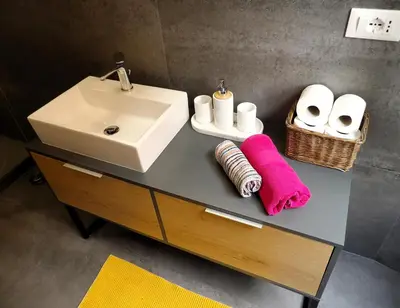 a bathroom with a sink and a counter with towels at Luxury Apartment - Centro Storico San Pietro in Rome