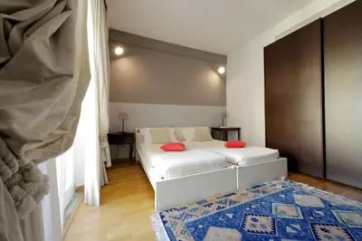 a bedroom with a bed with red pillows on it at YCH-Confortevole appartamento vicino Ponte Milvio in Rome