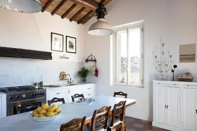 a kitchen with a table with a bowl of fruit on it at YourSuiteRome in Rome