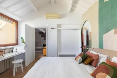 a bedroom with a large white bed and a desk at iFlat The Great Beauty in Rome
