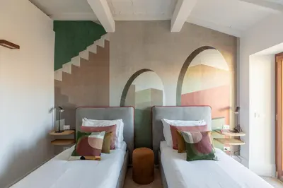 two beds in a room with arches on the wall at iFlat The Great Beauty in Rome
