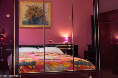 a bedroom with a bed in a glass case at Sophie's Choice in Rome