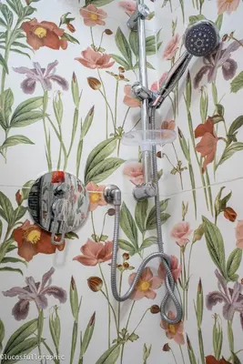 a shower head hanging on a wall with flowers at Sophie's Choice in Rome