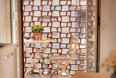 a table and a chair in front of a wall at Esclusivo Appartamento di design (metro Tiburtina) in Rome
