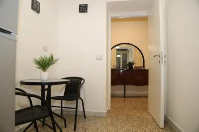 a room with a table and chairs and a mirror at MyWay RDR in Rome