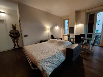 a bedroom with a bed and a table and chairs at Your Happy Home in Rome