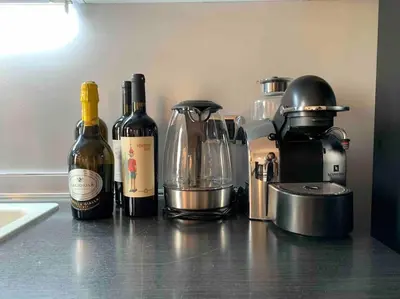 three bottles of wine sitting on a kitchen counter at Your Happy Home in Rome