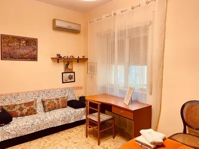 a living room with a couch and a desk at Rome Opéra Flat 2.0 in Rome