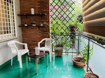 two white chairs and a table on a balcony at Rome Opéra Flat 2.0 in Rome