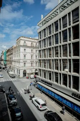 a city street with cars parked in front of buildings at OperaDreams2 in Rome