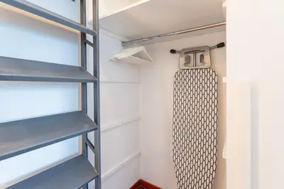 a walk in closet with a clock on the wall at The Attico: best view of Rome in Rome