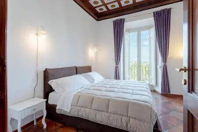 a bedroom with a bed and a large window at The Attico: best view of Rome in Rome