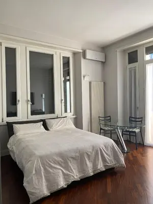 a bedroom with a bed and a glass table at A casa di Pele in Rome