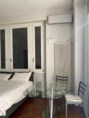 a bedroom with a glass table and a bed at A casa di Pele in Rome
