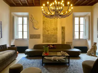 a living room with a couch and a chandelier at Monti Art Loft in Rome