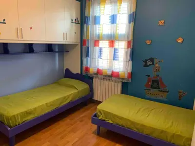a room with two beds and a window in it at In Città- appartamento a Roma con terrazzo in Rome