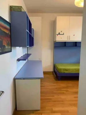 a small room with a blue counter and a bed at In Città- appartamento a Roma con terrazzo in Rome