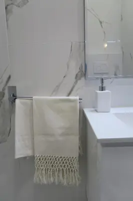 a bathroom with a towel hanging on a sink at Via Veneto Luxury Loft in Rome