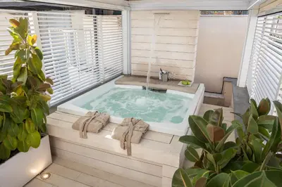 a jacuzzi tub in a room with a window at Amazing Piazza Venezia with Jacuzzi and terrace in Rome