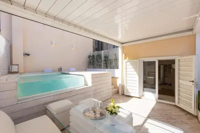 a swimming pool in a house with a patio at Amazing Piazza Venezia with Jacuzzi and terrace in Rome