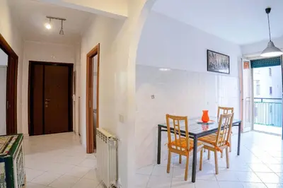 a dining room with a table and two chairs at Hostme Luminoso Appartamento Metro Marconi in Rome