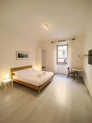 a bedroom with a bed and a desk in it at ViviRome - 2 Bedrooms Apartment - San Giovanni in Rome