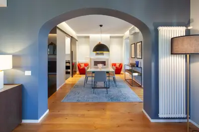 a dining room and living room with a table and chairs at Migliori Collection Penthouse in Rome