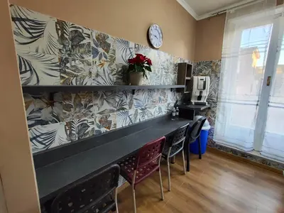 a bar in a restaurant with chairs and a clock on the wall at B&B Bella Garbatella in Rome