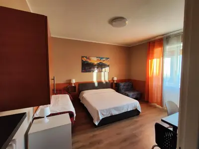 a bedroom with a bed and a chair in it at B&B Bella Garbatella in Rome