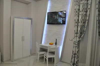 a dining room with a table and a wall at Il Corso Suite in Rome