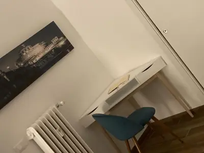 a room with a blue chair next to a stairs at Welcome to Rome Baldo in Rome