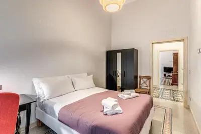 a bedroom with a bed with towels on it at Montebello Apartments79 in Rome