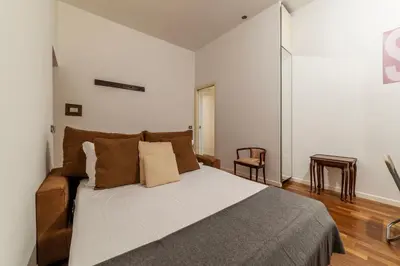 a bedroom with a large bed and a couch at A stone’s throw from the Colosseum! in Rome