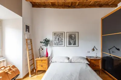 a bedroom with a bed and a wooden ceiling at iFlat Homey in Campo de'Fiori in Rome