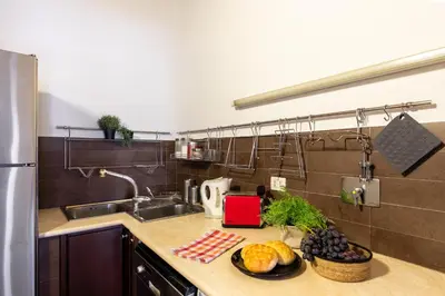 a kitchen with a sink and a plate of food on a counter at iFlat Homey in Campo de'Fiori in Rome