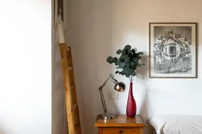 a table with a lamp and a plant in a vase at iFlat Homey in Campo de'Fiori in Rome