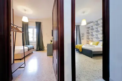 a room with a bedroom with a bed and a mirror at Comfy apartment next to Vatican City in Rome