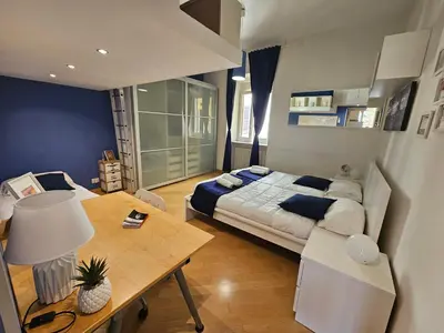 a bedroom with a large bed and a table at Domus Ottaviano - Vaticano in Rome