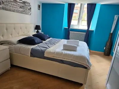 a bedroom with a large bed with blue walls at Domus Ottaviano - Vaticano in Rome