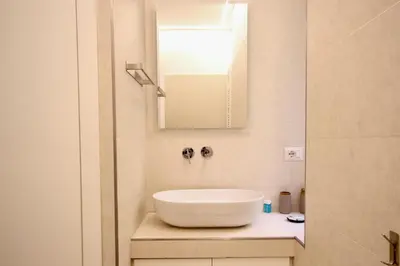 a bathroom with a white sink and a mirror at HC - Live Doria Luxury Apt by the Vatican in Rome
