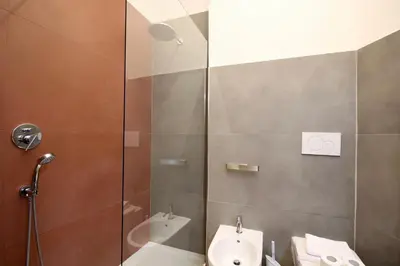 a bathroom with a shower and a toilet and a sink at HC - Live Doria Luxury Apt by the Vatican in Rome