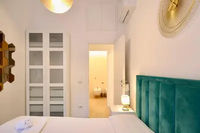 a bedroom with a bed with a green headboard at HC - Live Doria Luxury Apt by the Vatican in Rome