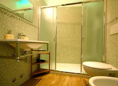 a bathroom with a shower and a toilet and a sink at Passenger Vatican Relais in Rome