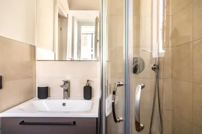 a bathroom with a sink and a shower at Testaccio Boutique Apartment in Rome in Rome