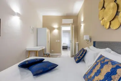 a bedroom with a bed with blue pillows on it at Vatican 2BR apartment in Roma in Rome