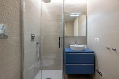 a bathroom with a sink and a glass shower at Vatican 2BR apartment in Roma in Rome