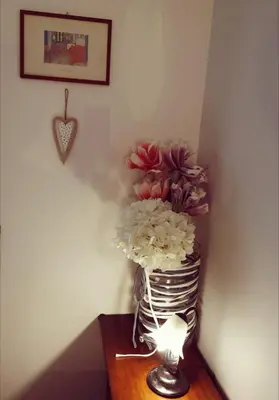a vase filled with flowers sitting on a table at Porta Maggiore GH Locazione Turistica in Rome