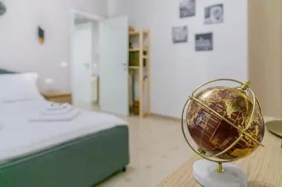 a globe sitting in a room next to a bed at Il rifugio dei nonni by Rentbeat in Rome