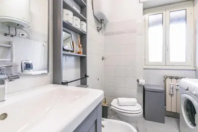 a white bathroom with a sink and a toilet at Il rifugio dei nonni by Rentbeat in Rome